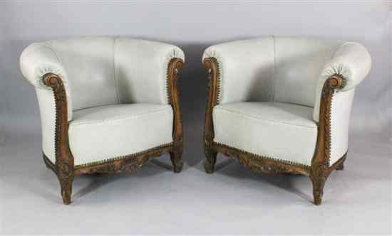 Appraisal: A pair of Edwardian carved and stained beech tub chairs