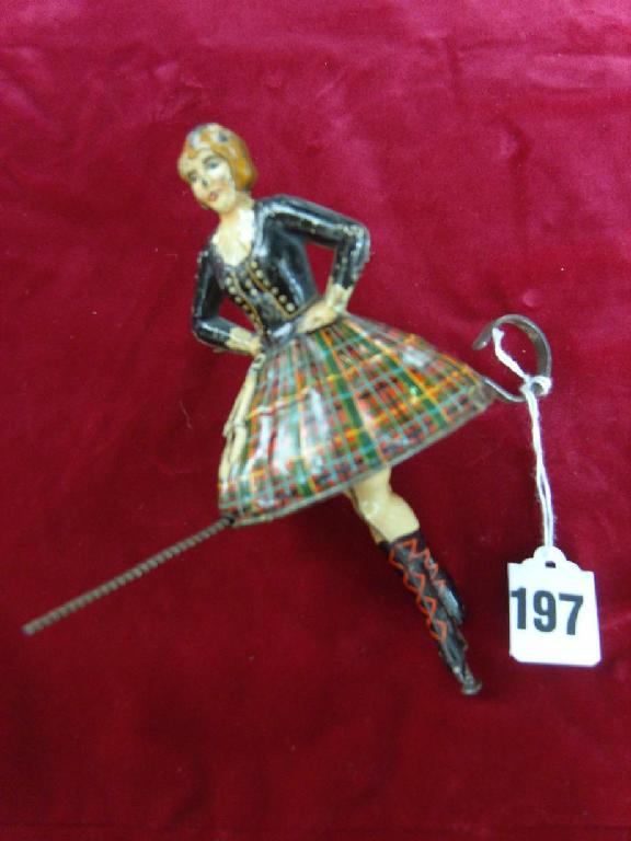 Appraisal: A tin plate female Highland dancer with printed finish