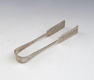 Appraisal: A pair of Victorian engraved serving tongs crested the grips