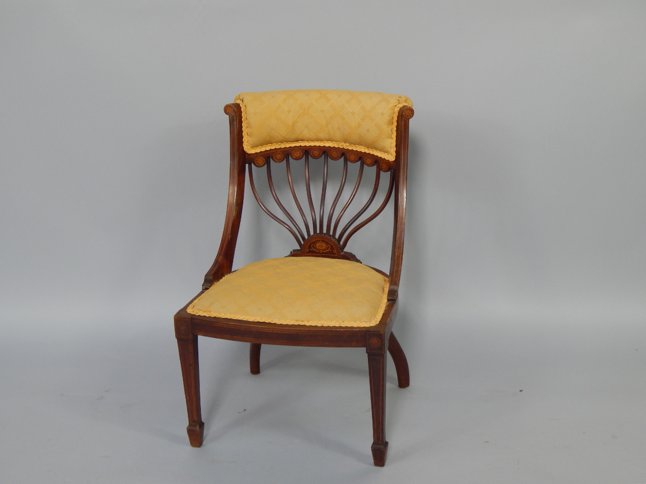 Appraisal: An Edwardian mahogany and satinwood inlaid nursing chair with overstuffed