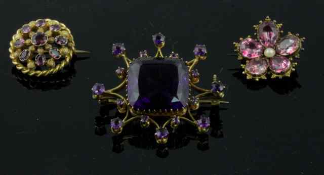 Appraisal: An amethyst set brooch the emerald cut central stone in