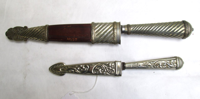 Appraisal: TWO ARGENTINE FIXED BLADE BOOT KNIVES the first decorative silver