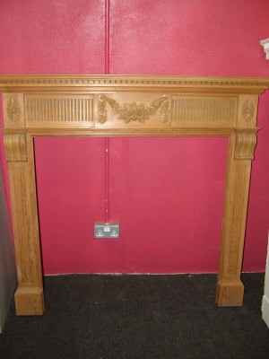 Appraisal: A Modern pine chimney piece the mantel above dentil moulded