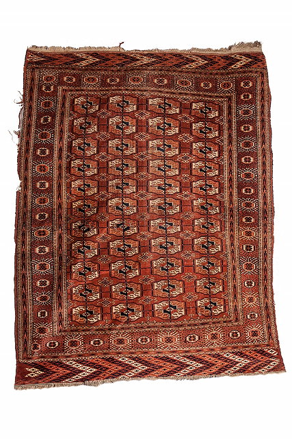 Appraisal: A PERSIAN YOMUT WINE GROUND RUG decorated four rows of