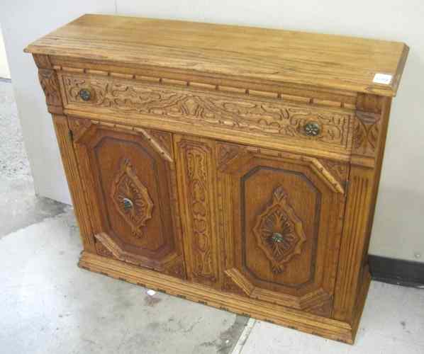 Appraisal: SMALL CARVED OAK SIDE CABINET American c 's the front