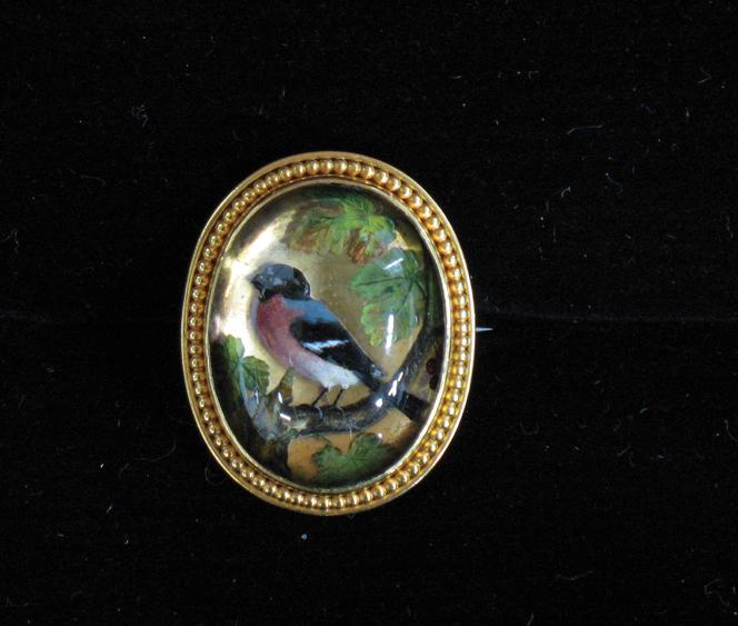 Appraisal: A REVERSE CRYSTAL INTAGLIO BROOCH depicting a finch sitting on