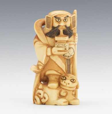 Appraisal: A Carved Ivory Statuette of a Figure with Foo Lion