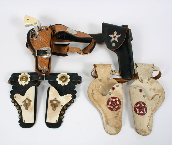 Appraisal: Toy holsters and gun two single and two double holsters