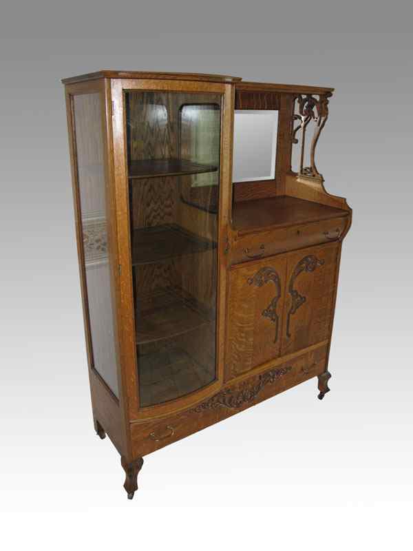 Appraisal: GOLDEN OAK SIDE BY SIDE CHINA CABINET Left side serpentine