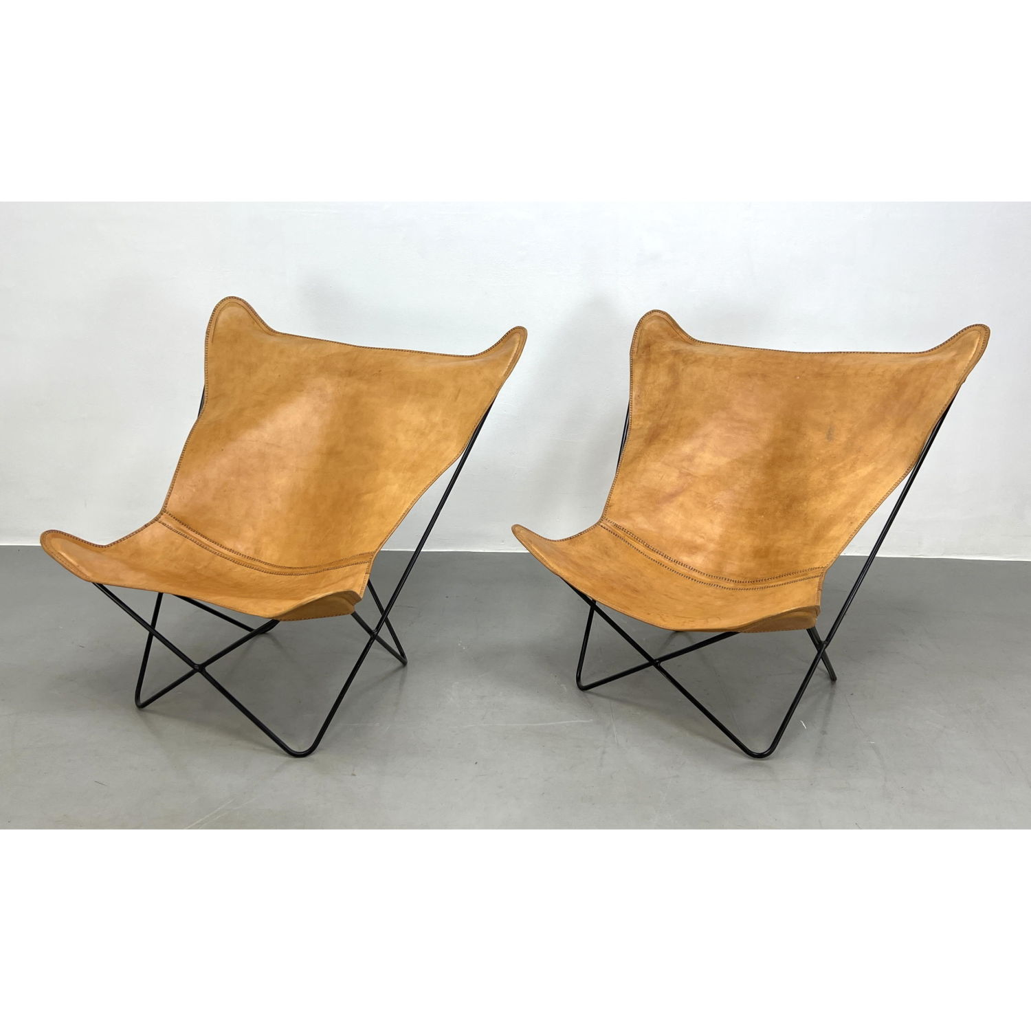 Appraisal: Pair of Leather Sling Butterfly Chairs Black Iron Frames Dimensions