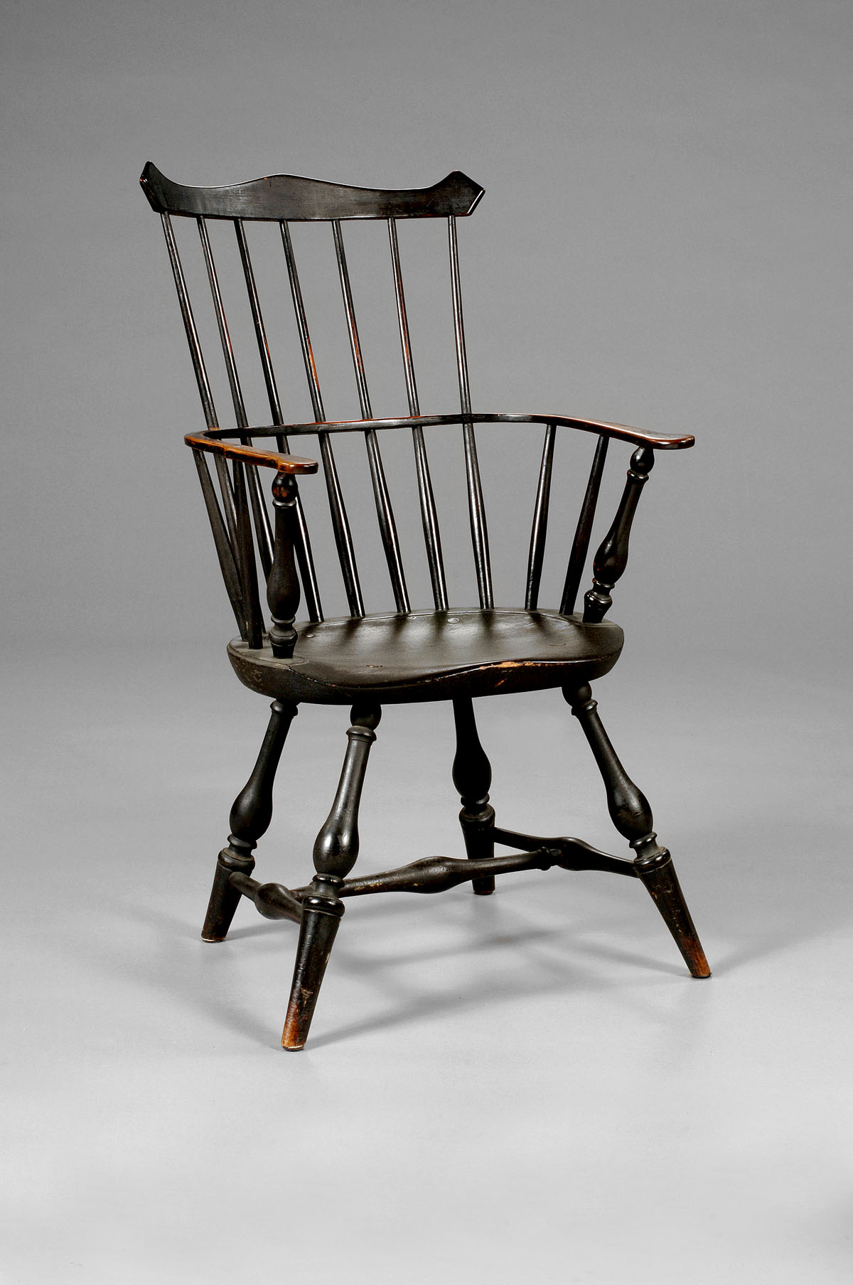 Appraisal: NEW ENGLAND COMB-BACK WINDSOR ARMCHAIR IN BLACK PAINT The arched