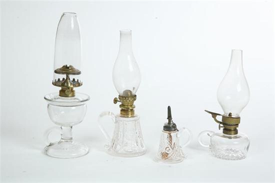 Appraisal: FOUR GLASS FINGER LAMPS Two are pattern glass bull's-eye variant