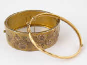 Appraisal: Two gilt metal bangles one hallmarked silver Birmingham