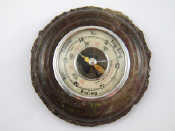 Appraisal: An aneroid barometer set in turned granite cm across