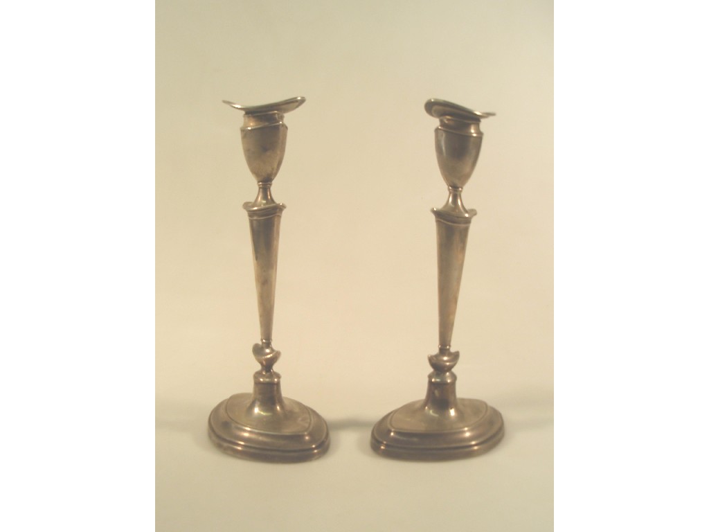 Appraisal: A pair of George V silver candlesticks of Adam design