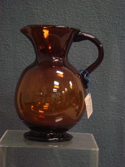 Appraisal: Clevenger amber free blown pitcher with applied crimped foot h