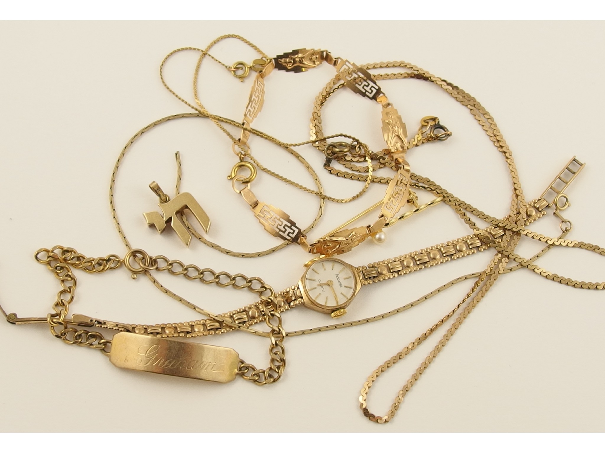 Appraisal: A collection of gold and yellow metal items to include