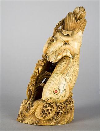 Appraisal: CHINESE CARVED AND STAINED IVORY FISH GROUP A leaping carp