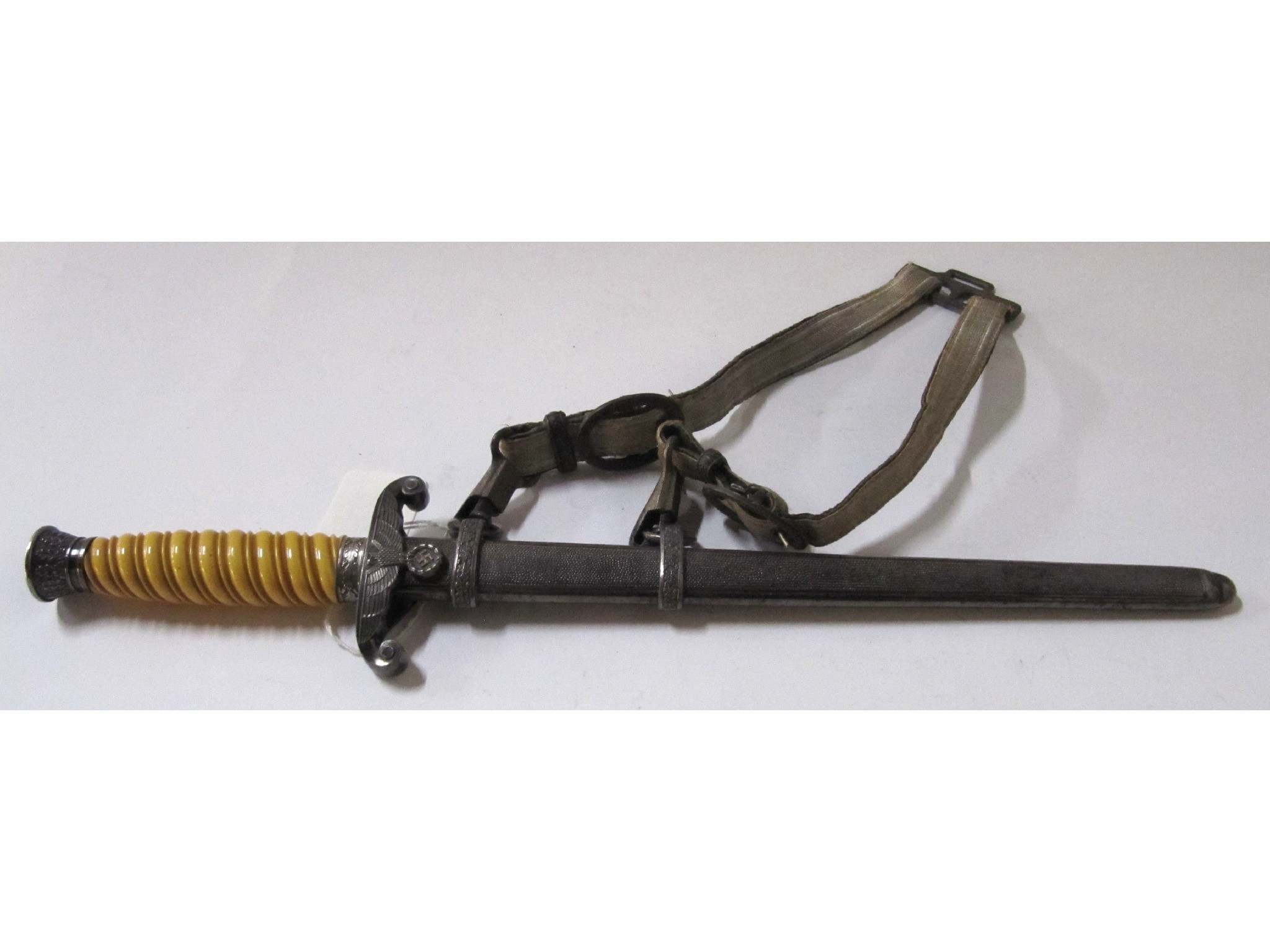 Appraisal: A German Luftwaffe dagger in scabbard with belt attachment the