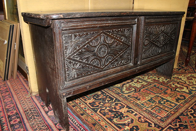 Appraisal: A SMALL OAK COFFER with chip carved two panelled front