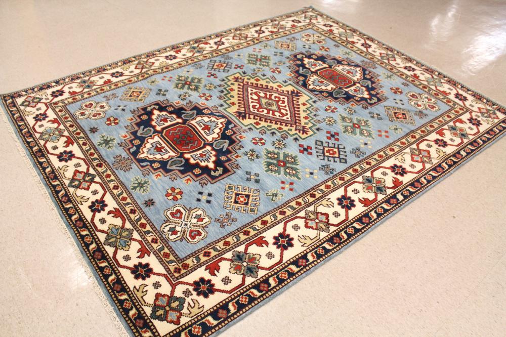 Appraisal: HAND KNOTTED ORIENTAL CARPET Indo-Caucasian three geometric medallions design on