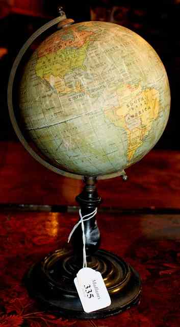 Appraisal: A PHILIP'S TERRESTRIAL GLOBE on turned ebonised support with circular