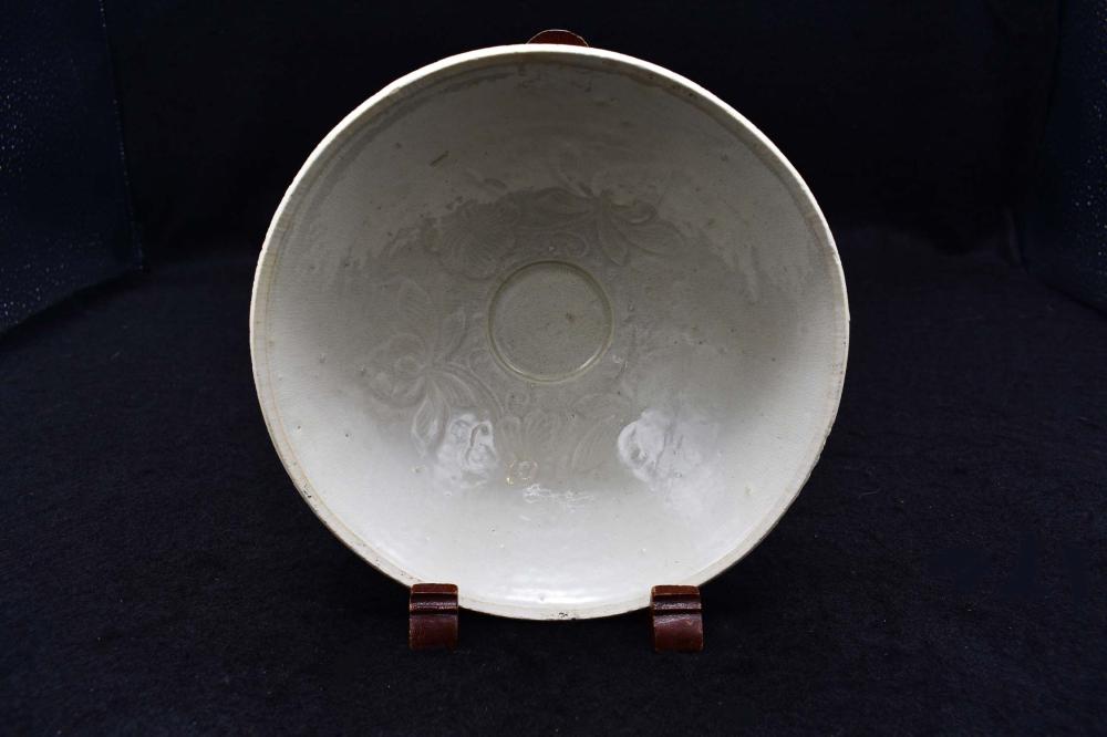 Appraisal: CHINESE SLIP DECORATED WHITE GLAZED BOWLIn a Song Dynasty style