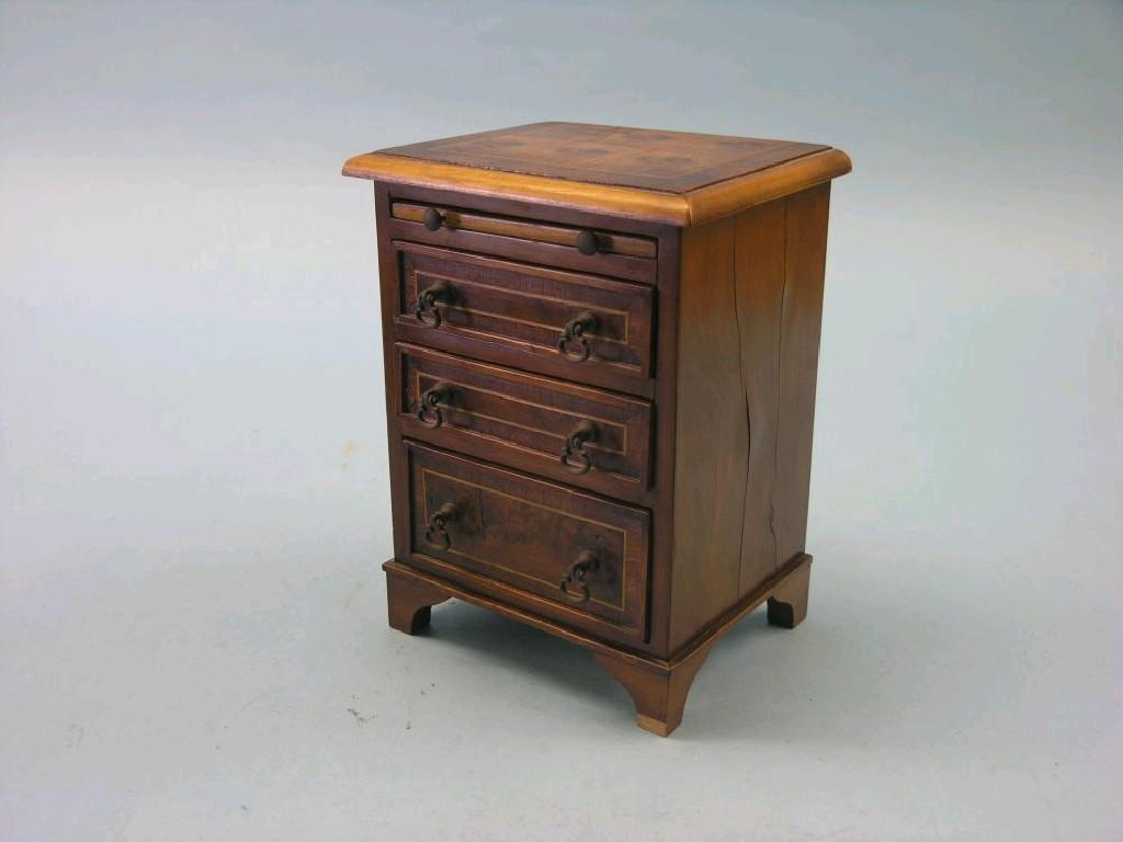 Appraisal: A miniature walnut bachelor chest cross-banded in mahogany brushing slide