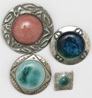 Appraisal: Four Ruskin Pottery metal mounted brooches glazed in shades of