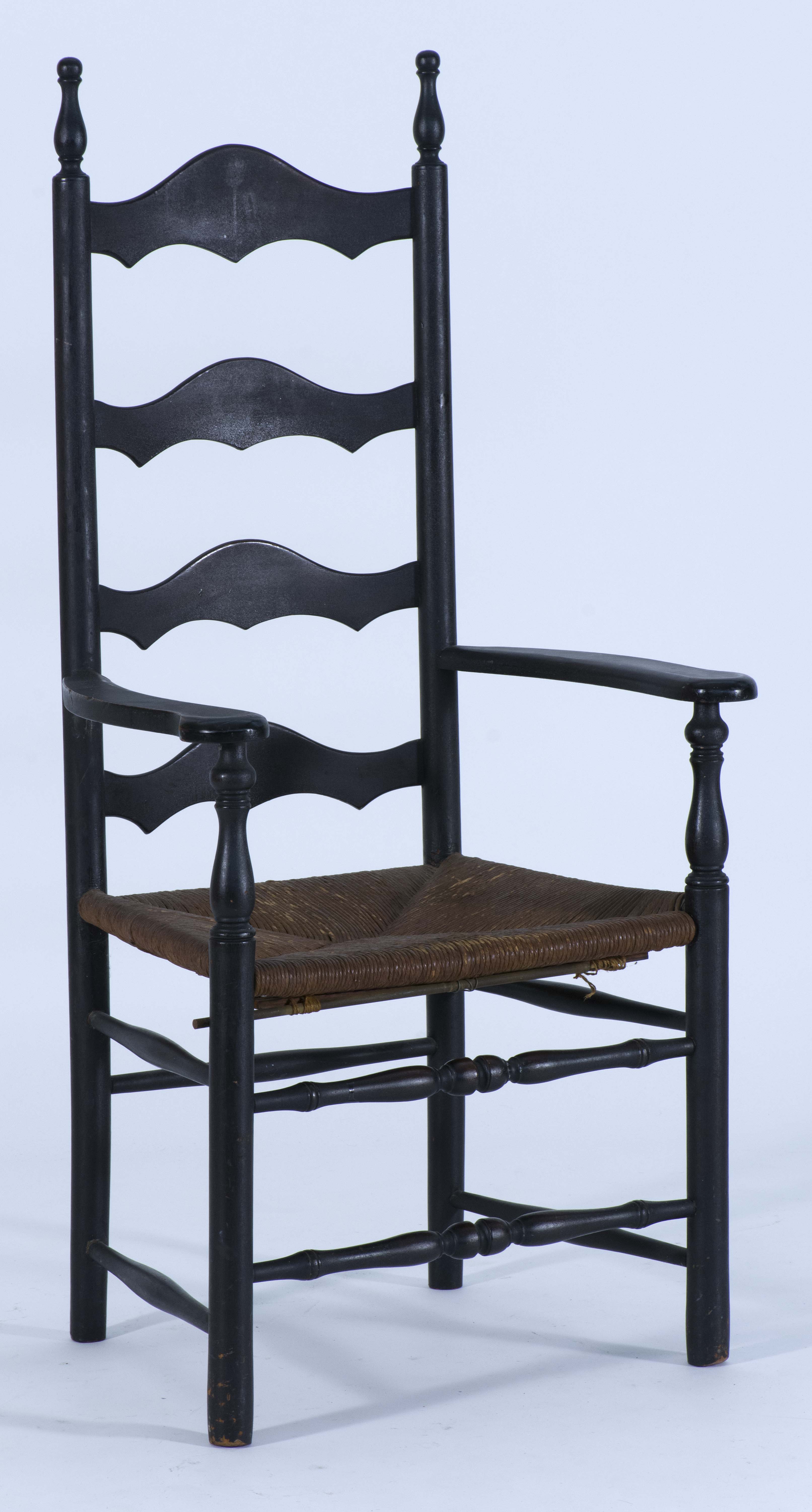 Appraisal: ANTIQUE AMERICAN LADDERBACK RUSH-SEAT ARMCHAIR th CenturyPainted black Overall height