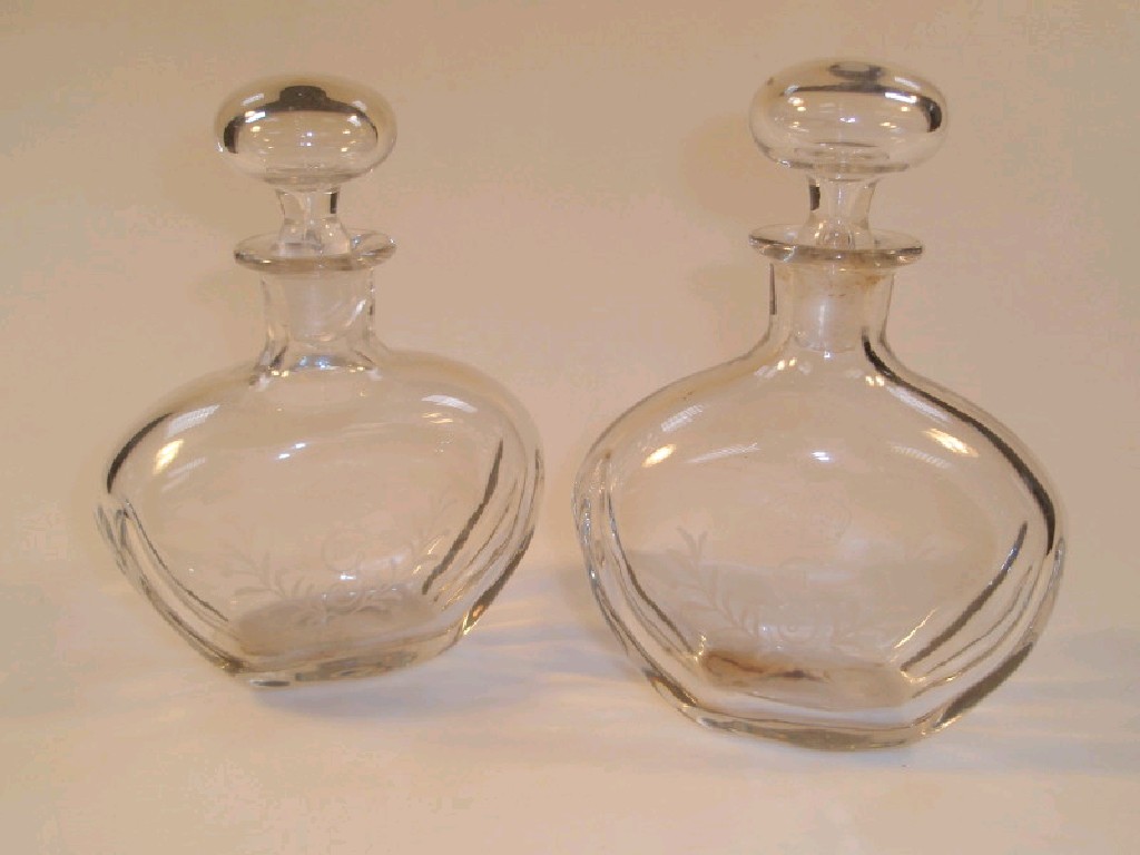 Appraisal: A pair of thC small glass decanters of flattened baluster