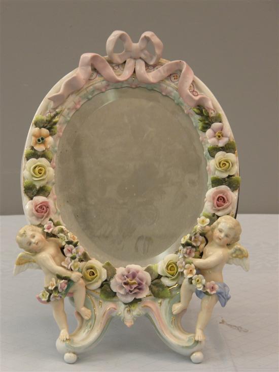 Appraisal: Sitzendorf porcelain framed oval strut mirror with applied cherub and