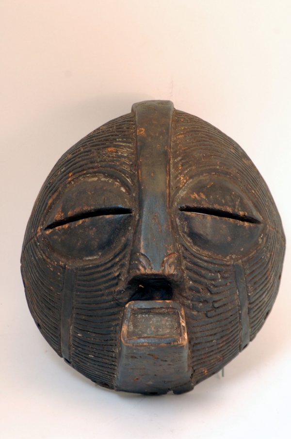 Appraisal: A Songye Kifwebe mask of round form with allover linear