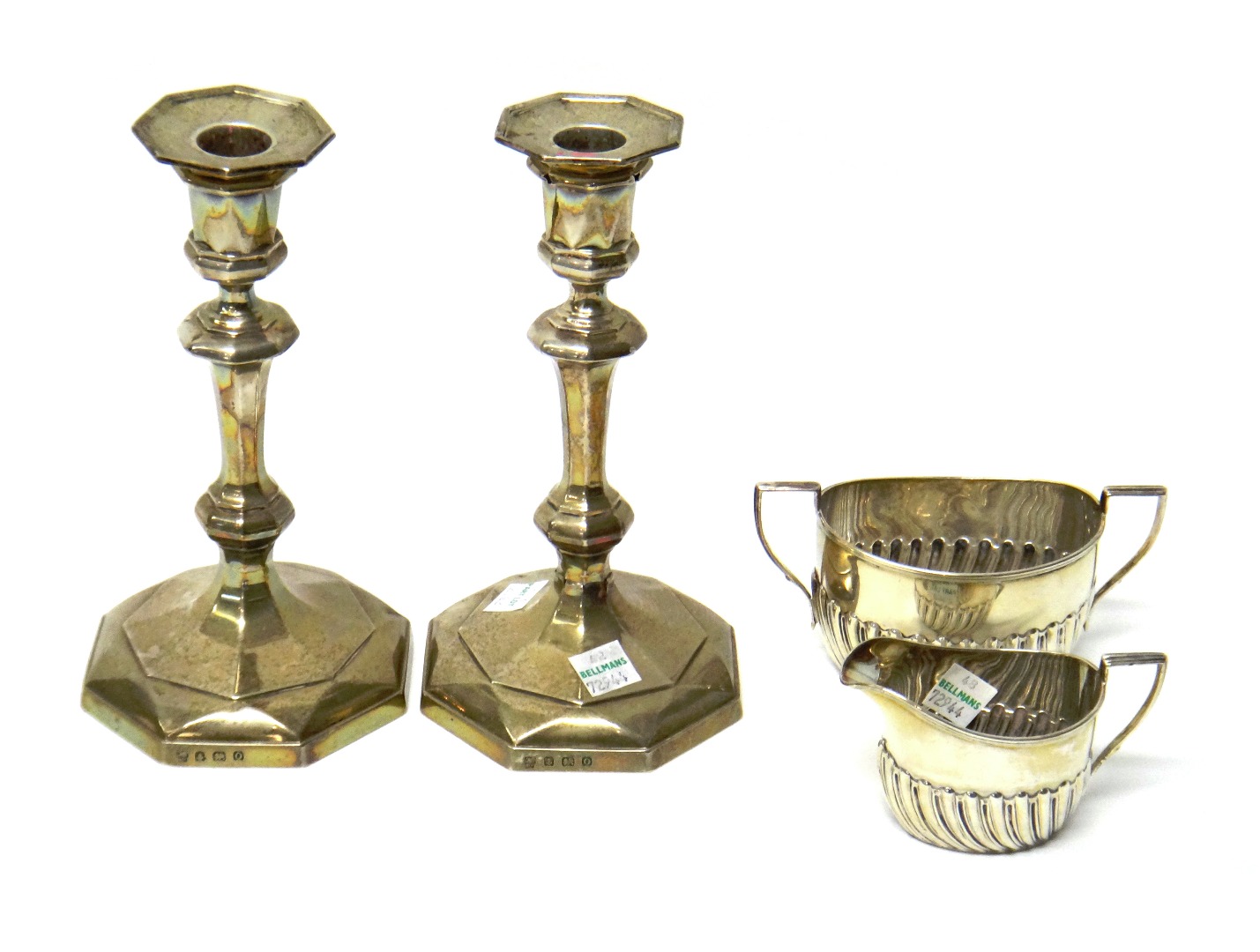 Appraisal: A pair of George VI silver candlesticks Birmingham of faceted