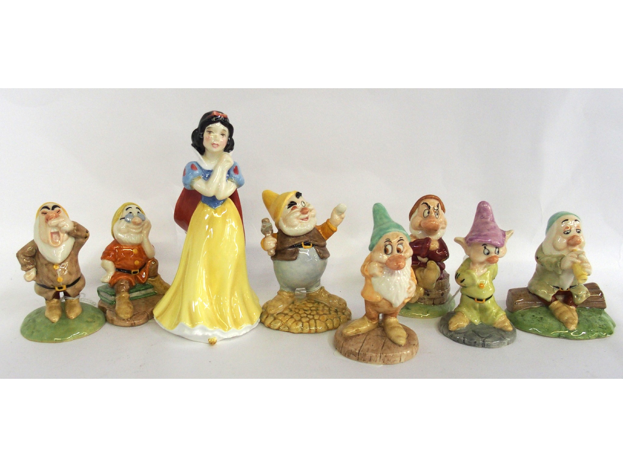 Appraisal: Royal Doulton Snow White and the Seven Dwarves figures with