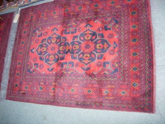 Appraisal: A SIMILAR RED GROUND RUG x approx