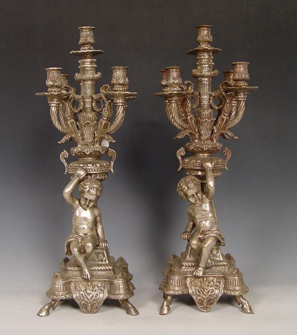 Appraisal: PAIR ORNATE WHITE BRASS CHERUBIC CANDELABRUM Cast cherubic base each