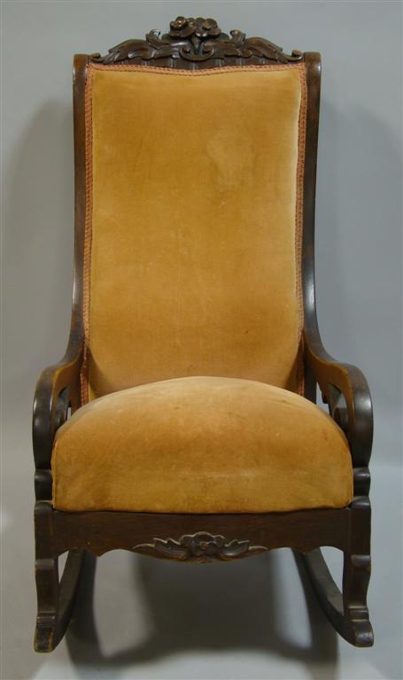 Appraisal: VICTORIAN VELVET UPHOSLTERED ROCKING CHAIR the floral carved crestrail over