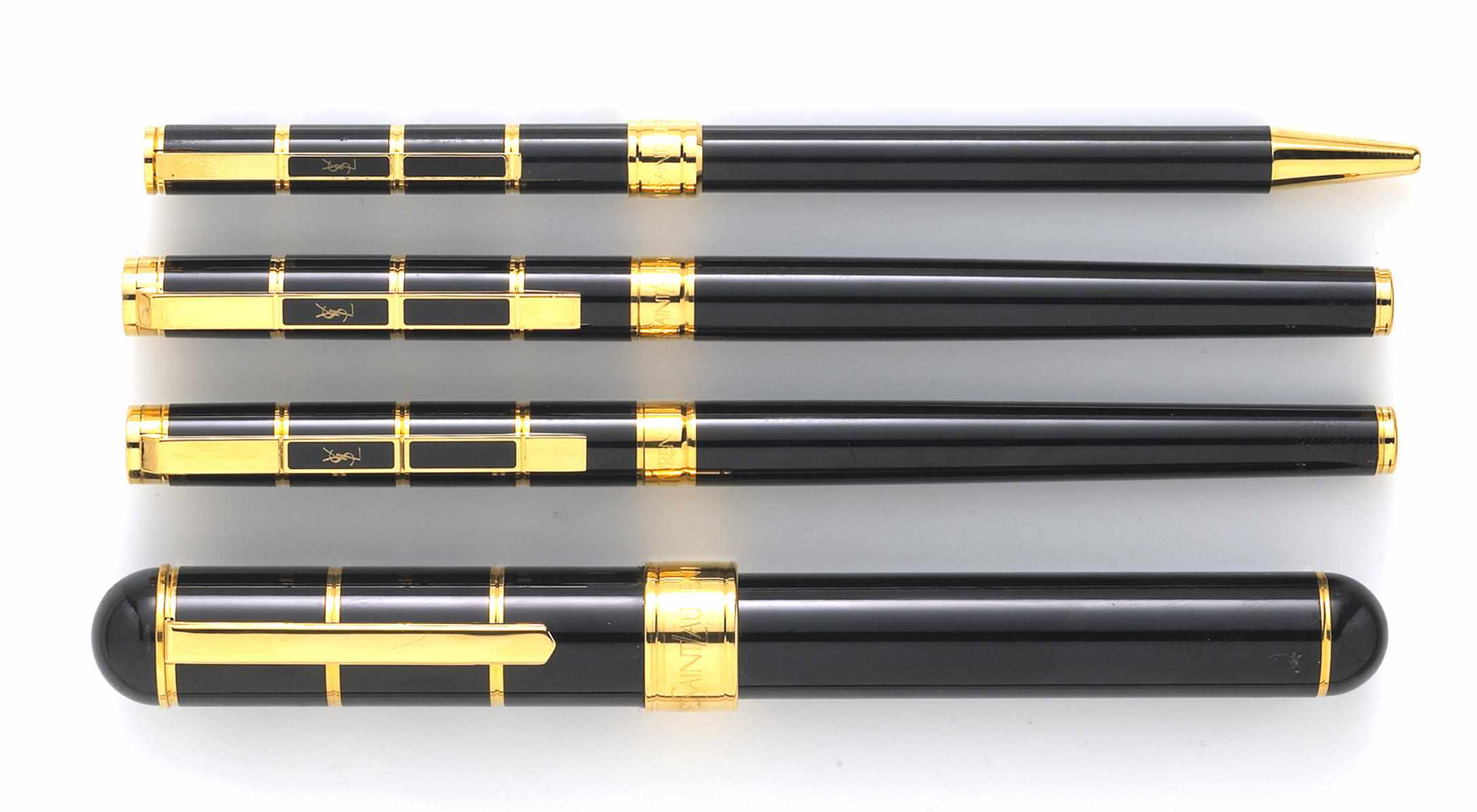 Appraisal: Yves St Laurent Four Pens In black with gold trim