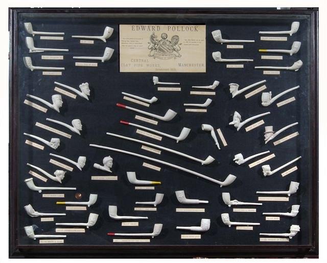 Appraisal: A COLLECTION OF FIFTY EDWARD POLLOCK CLAY PIPES in a