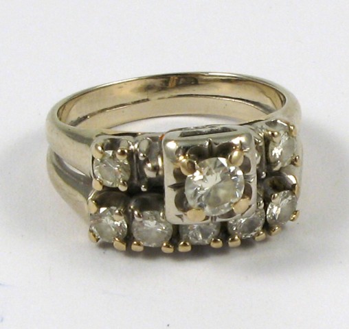 Appraisal: DIAMOND AND FOURTEEN KARAT GOLD RING with a larger round-cut