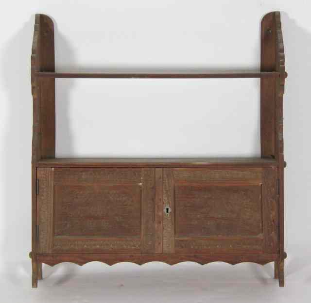 Appraisal: A wall hanging cabinet with shelf over carved panel doors