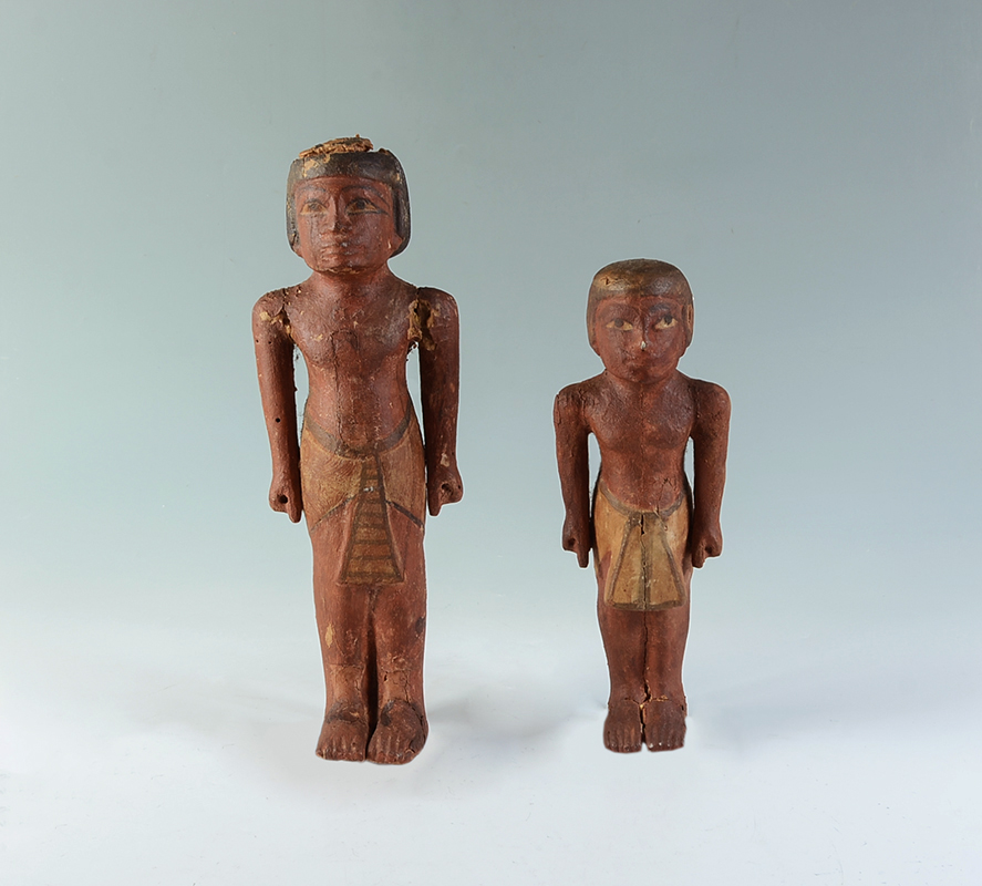 Appraisal: TWO EGYPTIAN CARVED ANTIQUITY FIGURES Male and female burial figures