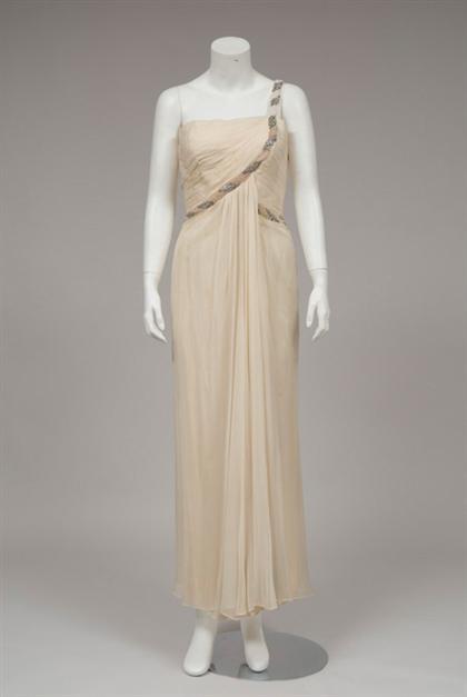 Appraisal: Cream chiffon draped sleeveless goddess gown s Shirred shaped bodice