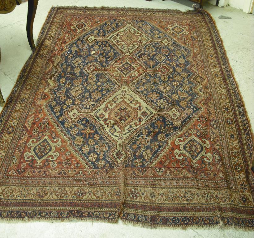 Appraisal: Shiraz rug the indigo field with three lozenge motifs and