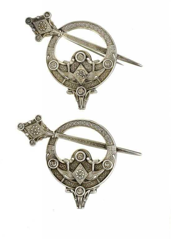 Appraisal: TWO IRISH CELTIC REVIVAL SILVER ANNULAR BROOCHES in the form