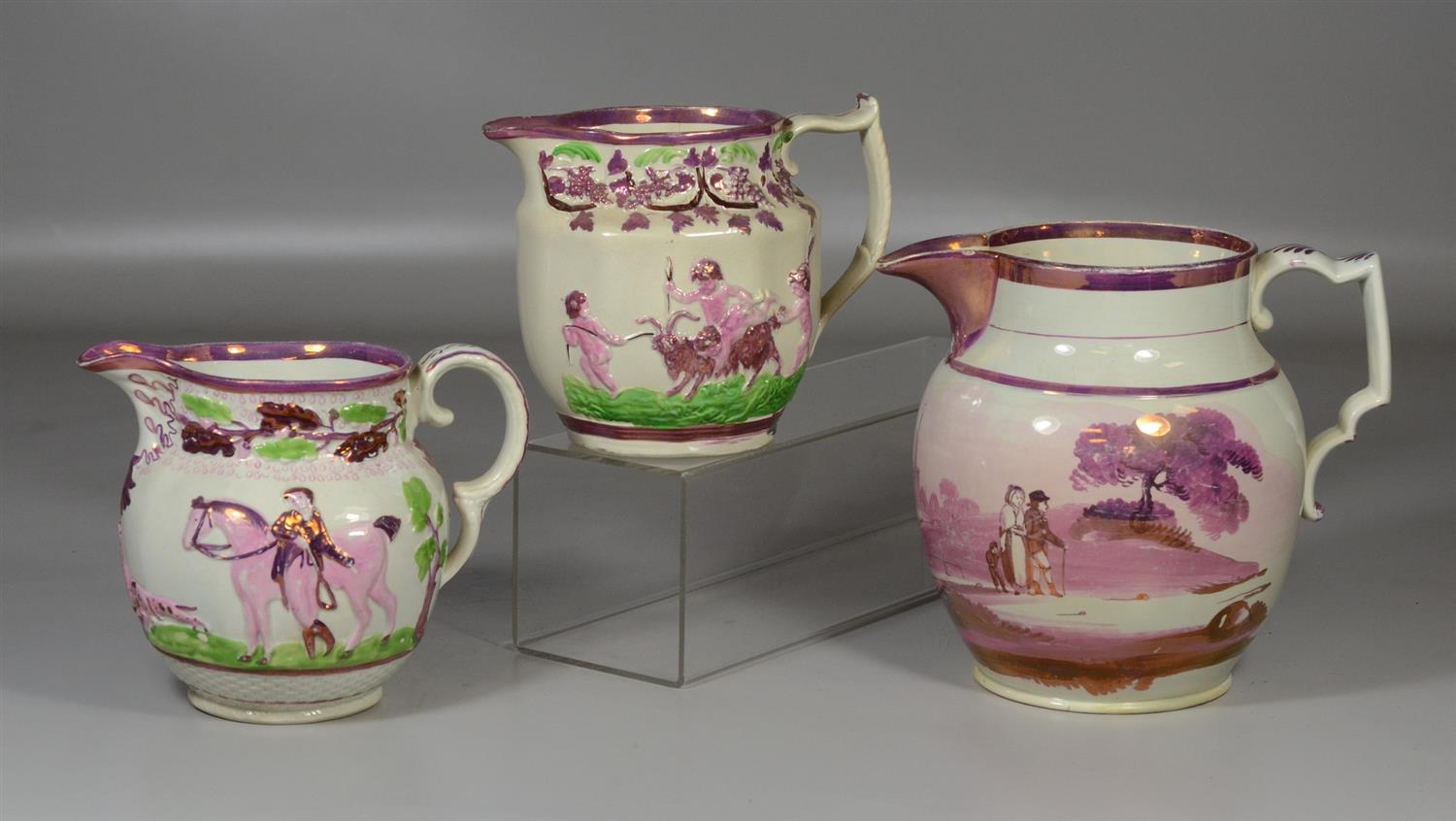 Appraisal: Three English pink luster pitchers one decorated with cherubs and