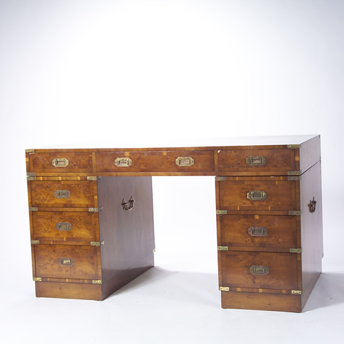 Appraisal: Campaign style desk with birds eye veneer Nine drawers and