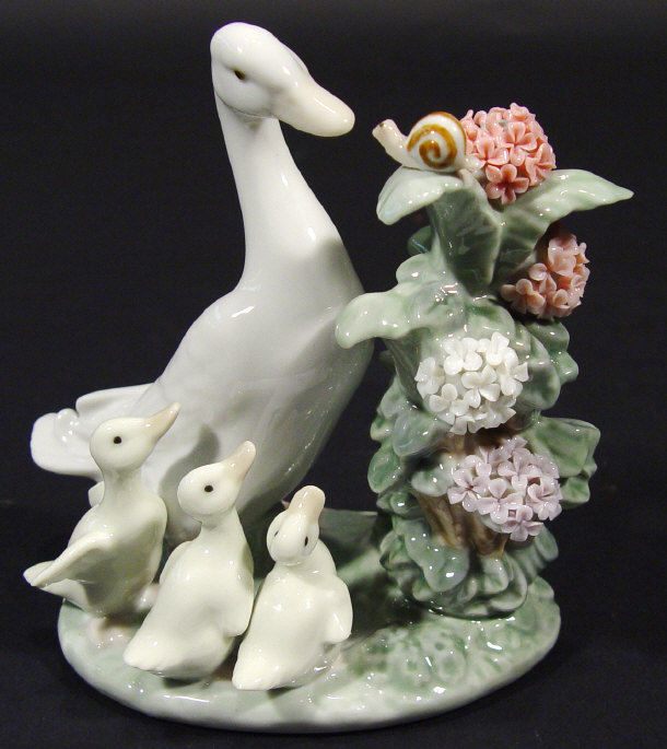 Appraisal: Lladro porcelain duck group beside a floral plant with hand