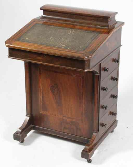 Appraisal: A late Victorian walnut Davenport with hinged stationery compartment to